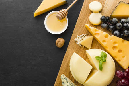 flat lay mix gourmet cheese grapes cutting board with honey. High quality beautiful photo conceptの写真素材