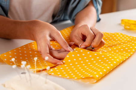 hands sewing fabric. High quality photoの写真素材