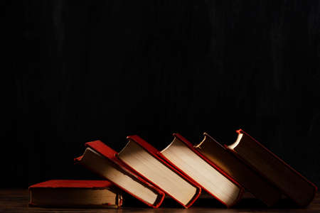 books assortment with dark background. High quality photoの写真素材