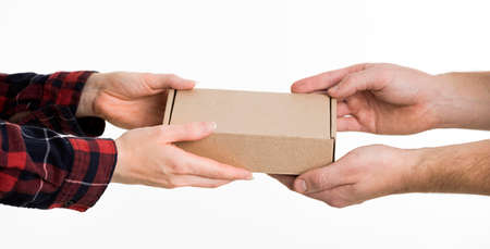hands exchanging cardboard box. High quality photoの写真素材