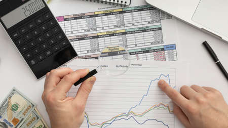 top view business man studying graph. High quality photoの写真素材