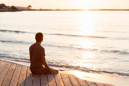 man meditating beach. High quality photoの写真素材