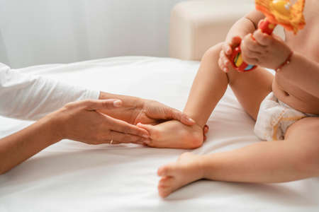 osteopathist treating baby girl s feet. High quality photoの写真素材