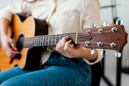 female musician playing acoustic guitar. High quality photoの写真素材
