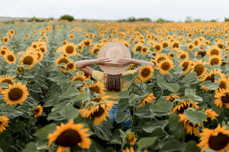 back view woman wearing hat outdoors. High quality photoの写真素材