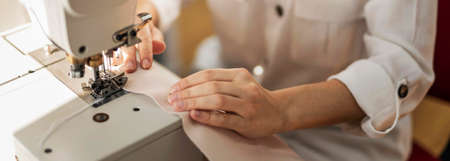 close up woman working with sewing machine. High quality photo
