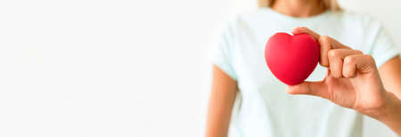 front view defocused woman holding heart shape. High quality photoの写真素材