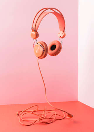 pink headphones with cable flying. High quality photoの写真素材