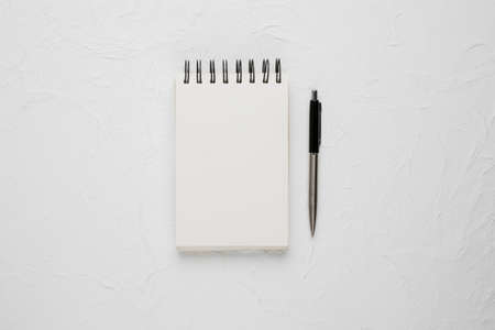 high angle view white blank spiral notepad with ballpoint pen. High quality photoの写真素材