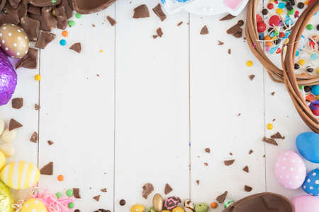 easter chocolate eggs with candies wooden table. High quality photo