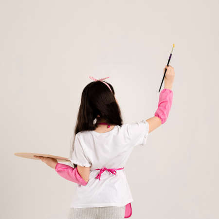 young girl painting back view. High quality photo
