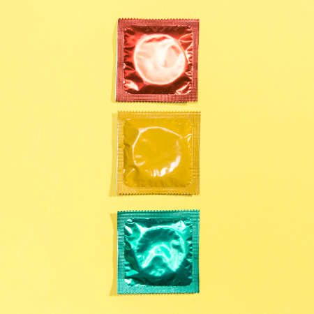 top view red yellow green condoms. High quality photo