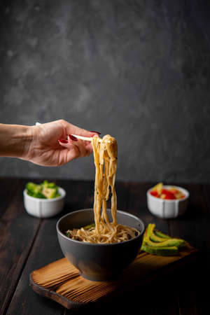 noodles bowl with avocado copy space. High quality photo
