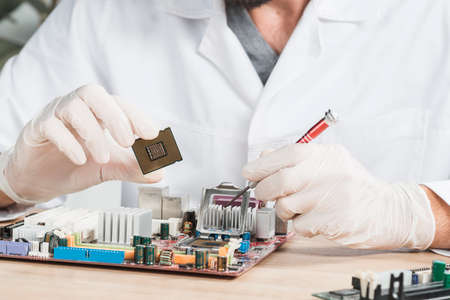 close up male technician holding computer chip. High quality photo
