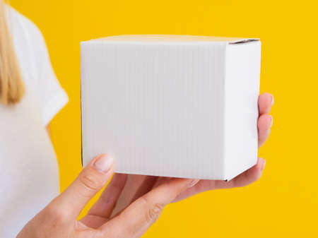 woman holding up small box. High quality photo