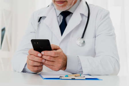 doctor using his phone. High quality photoの写真素材