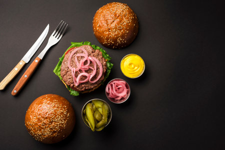top view beef burger with sauces cutlery. High quality photoの写真素材