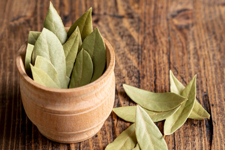 high angle wooden bowl with bay leaves. High quality photo