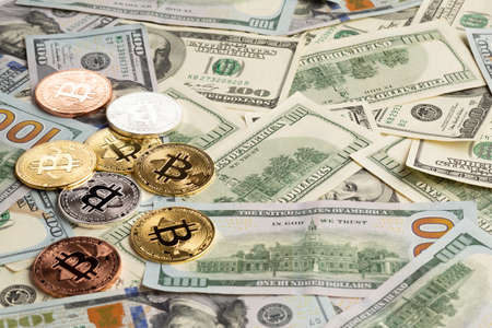 different colored bitcoin top dollar bills. High quality photoの写真素材