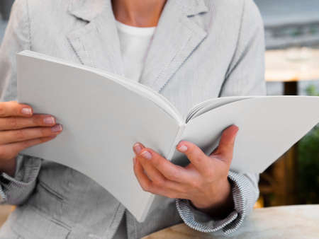 close up woman reading mock up magazine. High quality photoの写真素材