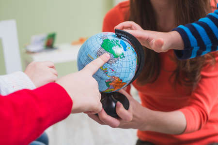 children touching globe. High quality photoの写真素材