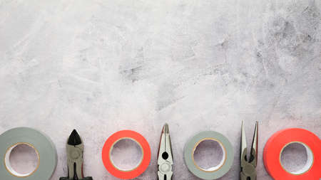 insulating tape plier arranged row white cement concrete floor. High quality photoの写真素材