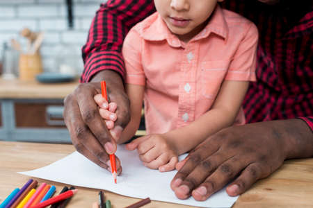 black father son drawing paper. High quality photoの写真素材