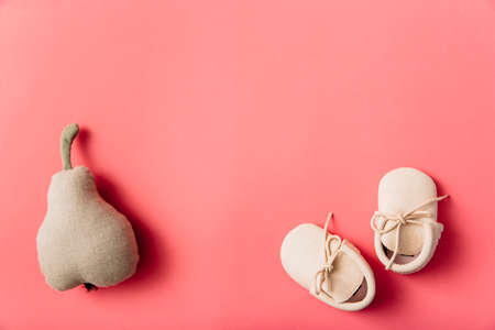 stuffed pear fruit pair baby s shoes colored background. High quality photoの写真素材