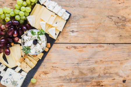platter cheese with grapes black slate board table. High quality photoの写真素材