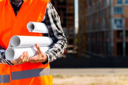 construction engineer holding plans hands. High quality photo
