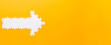 arrow made with puzzle pieces pointing right. High quality photoの写真素材