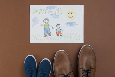 daddy me drawing with man child shoes. High quality photoの写真素材