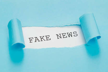 high view fake news message torn red paper. High quality photo