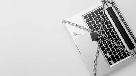 top view laptop protected by metal chain lock with copy space. High quality photo
