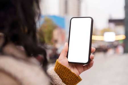 woman holding blank smartphone outside. High quality photoの写真素材