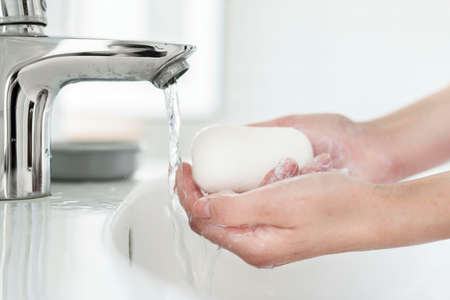side view hands washing bar soap sink. High quality photo