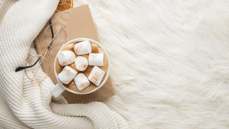 top view cup hot marshmallows glasses book. High quality photoの写真素材