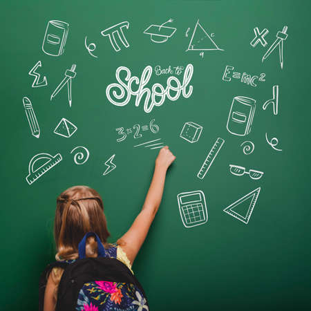 medium shot girl writing green board. High quality photoの写真素材