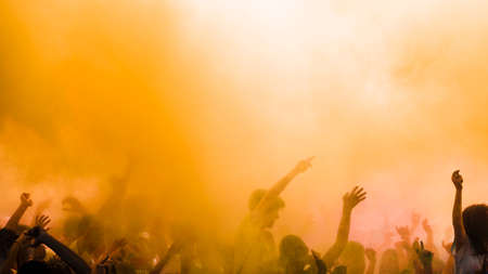yellow color explode crowd enjoying holi festival. High quality photoの写真素材