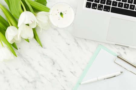 laptop with tulips clipboard light table. High quality photoの写真素材