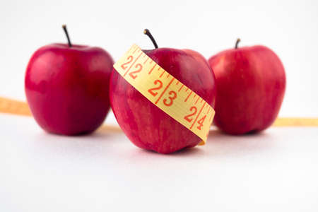 three apples with measuring tape table. High quality photoの写真素材