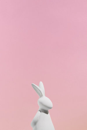 white rabbit figurine pink background. High quality photoの写真素材