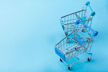 shopping carts blue background with copy space. High quality photo