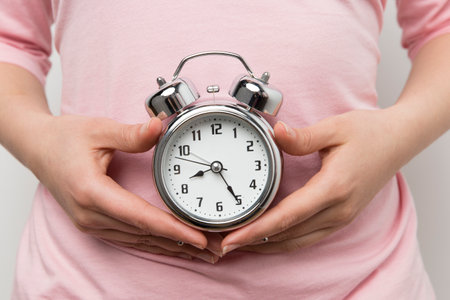 girl holding alarm clock. High quality photoの写真素材