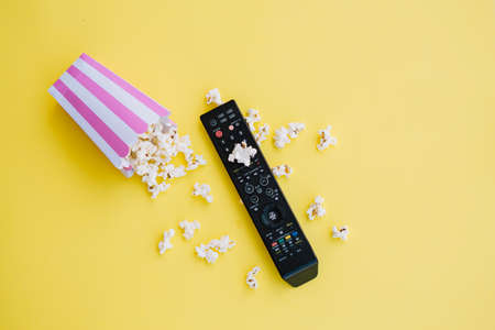 tv remote control near spilled popcorn. High quality photoの写真素材