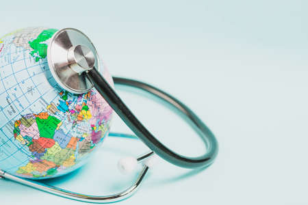 globe care with stethoscope blue background. High quality photoの写真素材