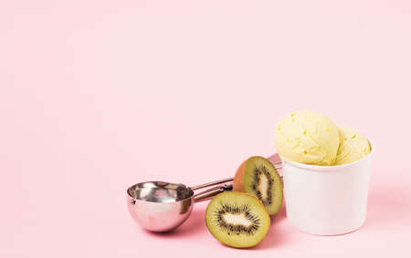 ice cream balls cup near kiwi scoop. High quality photoの写真素材
