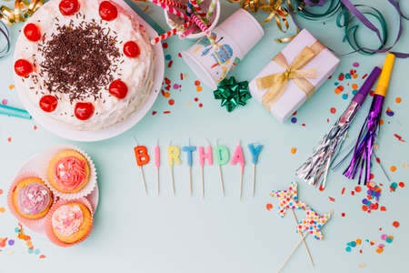 word birthday candles party accessories cake blue backdrop. High quality photoの写真素材