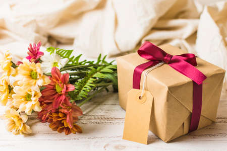 present box with brown tag flower bunch table. High quality photoの写真素材