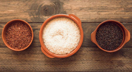 panoramic view three different organic rice bowls wooden table. High quality photoの写真素材